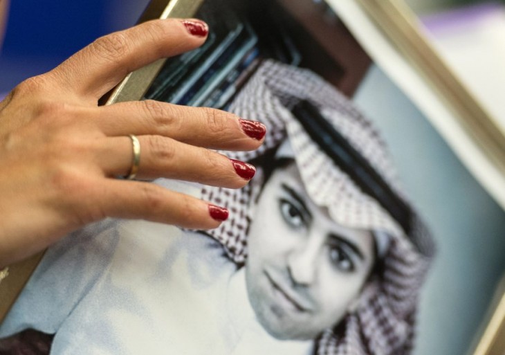 epa05070938 Ensaf Haidar, wife of jailed Saudi blogger Raif Badawi, holds a picture of her husband during a press conference in the European Parliament in Strasbourg, France, 16 December 2015. Raif Badawi, who is serving a prison term in Saudi Arabia for allegedly insulting Islam, was awarded the European Parliament's Sakharov Prize for Freedom of Thought on 16 December, due to exceptional courage which had earned him 'one of his country's most gruesome punishments,' parliament President Martin Schulz has said.  EPA/PATRICK SEEGER