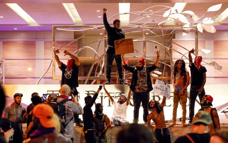 People gather in front of the Ritz-Carlton in uptown Charlotte, NC during a protest of the police shooting of Keith Scott, in Charlotte, North Carolina, U.S. September 21, 2016. REUTERS/Jason Miczek