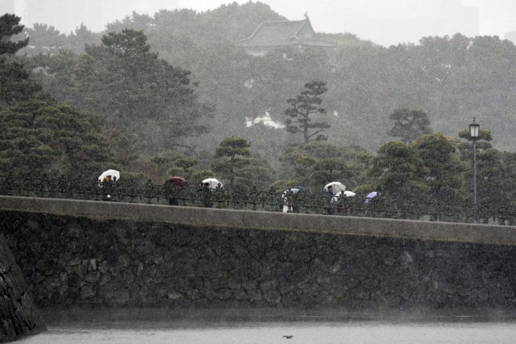 epaselect epa05644764 Tourists visit the surrounding gardens of the Imperial Palace during snowfall in Tokyo, Japan, 24 November 2016. Snow fell in Tokyo for the first time in the month of November in 54 years. According to media reports, snow has not accumulated in central Tokyo since 1875.  EPA/FRANCK ROBICHON