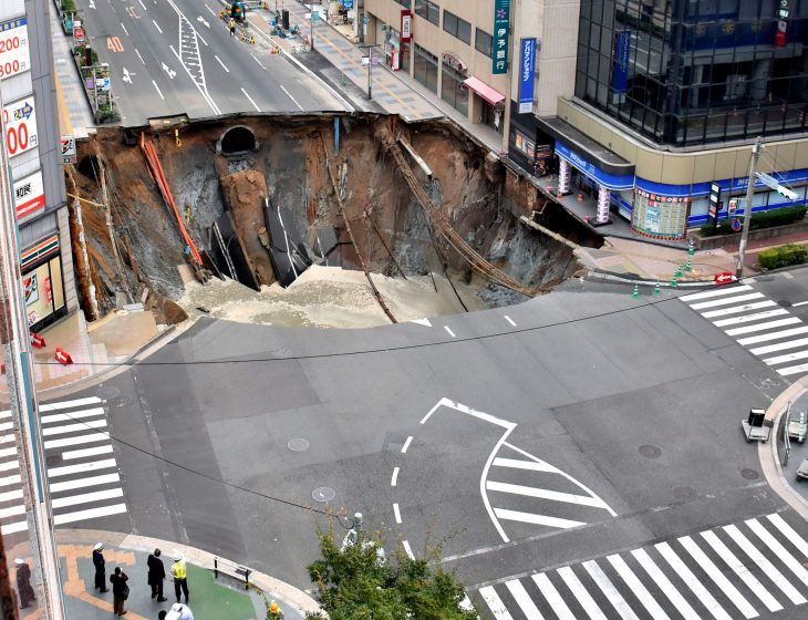 A huge sinkhole is seen at an intersection near Hakata station in Fukuoka, Japan, November 8, 2016 in this photo taken by Kyodo.  Mandatory credit Kyodo/via REUTERS ATTENTION EDITORS - THIS IMAGE WAS PROVIDED BY A THIRD PARTY. EDITORIAL USE ONLY. MANDATORY CREDIT. JAPAN OUT. NO COMMERCIAL OR EDITORIAL SALES IN JAPAN. THIS IMAGE WAS PROCESSED BY REUTERS TO ENHANCE QUALITY, AN UNPROCESSED VERSION HAS BEEN PROVIDED SEPARATELY.     TPX IMAGES OF THE DAY.